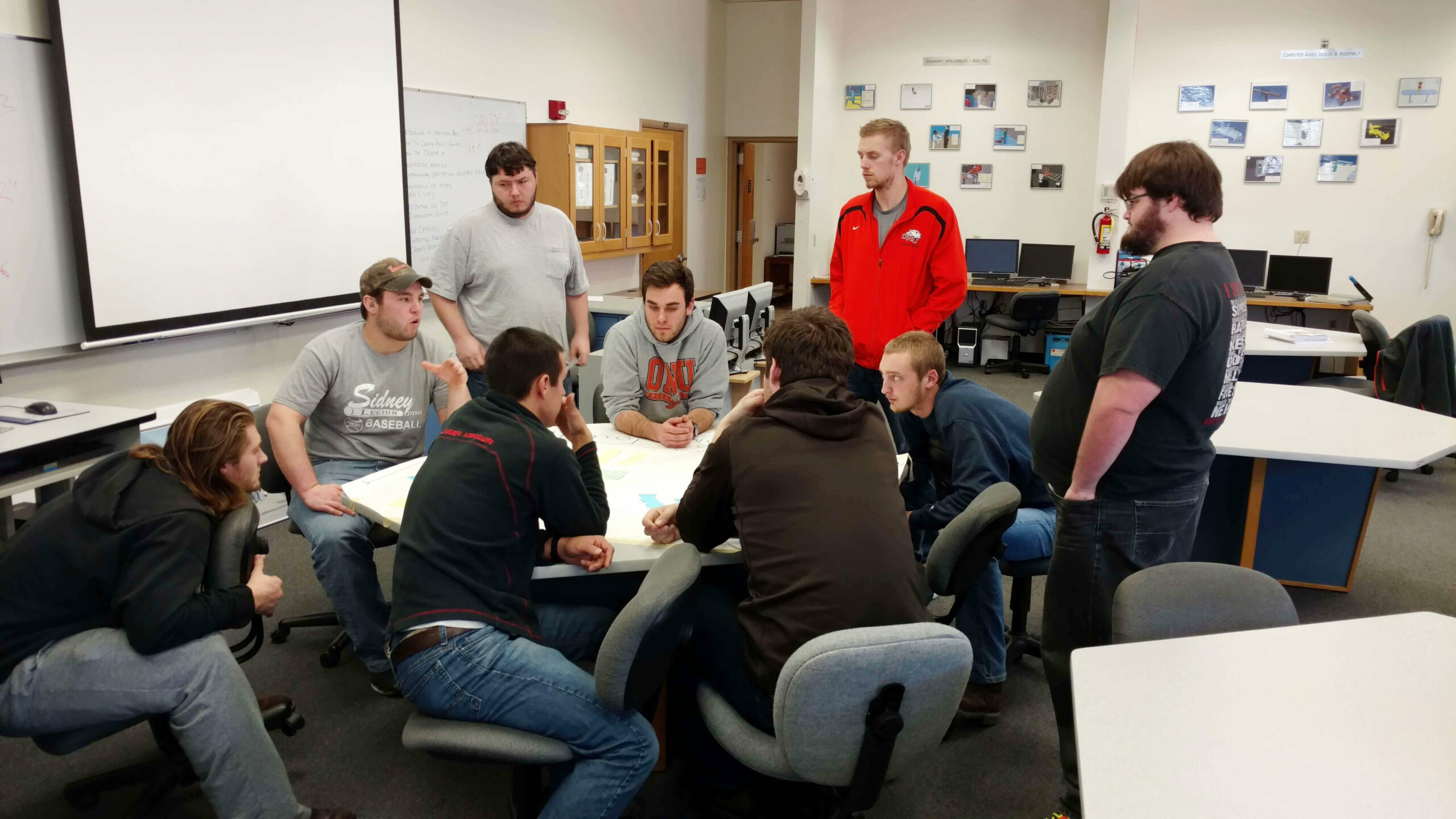 nine Ohio Northern University students working on a factory simulation project